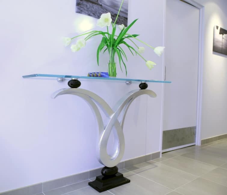 Zodiaco, Console with glass top, structure with silver leaf finish , for hall entrance furnishing